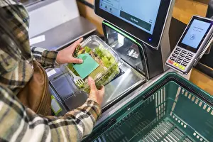 Cashless Payment Systems Prints: Woman using a self checkout machine