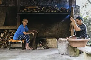 Women In The Kitchen Prints: Two women work in a rustic kitchen
