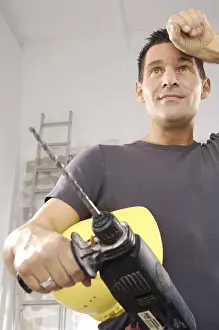 Safety Helmet Prints: Workman holding a drill