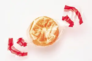 Food Still Life Image Prints: Wrapped fruit candy in the shape of an orange slice