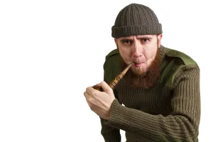 Guy Looking At Camera Prints: Young bearded guy smoking a pipe on a light background