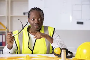 One Person Working Prints: Young black architect working on project
