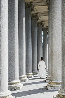 Classic Architecture Photos Prints: A young girl walks gracefully among towering columns