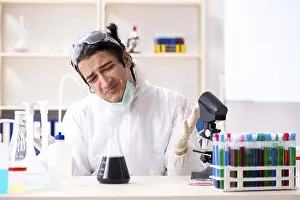 Handsome Chemist Prints: Young handsome chemist working in the lab
