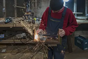 Young Man In Workshop Prints: Young man at a Flex in his workshop