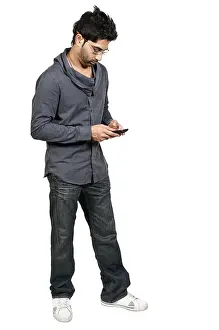 Online Communication Prints: Young man using a cell phone for texting
