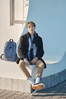Self Confident Male Prints: Young student with backpack in old wool coat