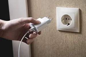 Power Supply Line Image Prints: A young woman inserts a plug into a socket