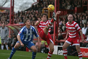 Alex Revell watches Graeme Lee clear the ball Alex Revell watches Graeme Lee clear the ball