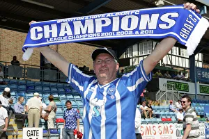 A fan celebrates our League 1 success in 2011 A fan celebrates our League 1 success in 2011
