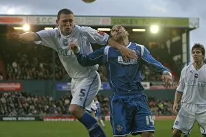 Images Dated 18th December 2006: Joel Lynch beats Oldhams Paul Warne to a header